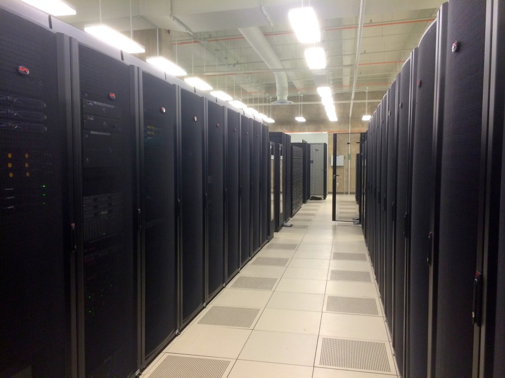 Here are two long rows of server racks in one of the main server pods. Each rack holds multiple computers, as well as sometimes running thousands of virtualized instances of servers.
